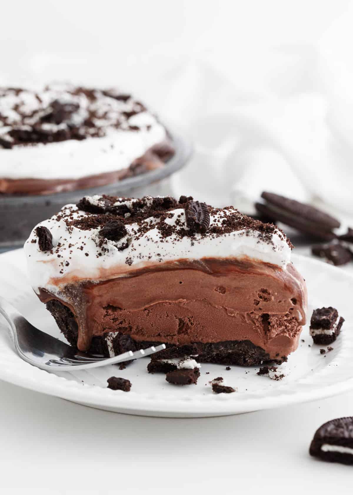 Slice of mud pie on a white plate.
