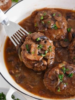 Salisbury steak in a skillet.
