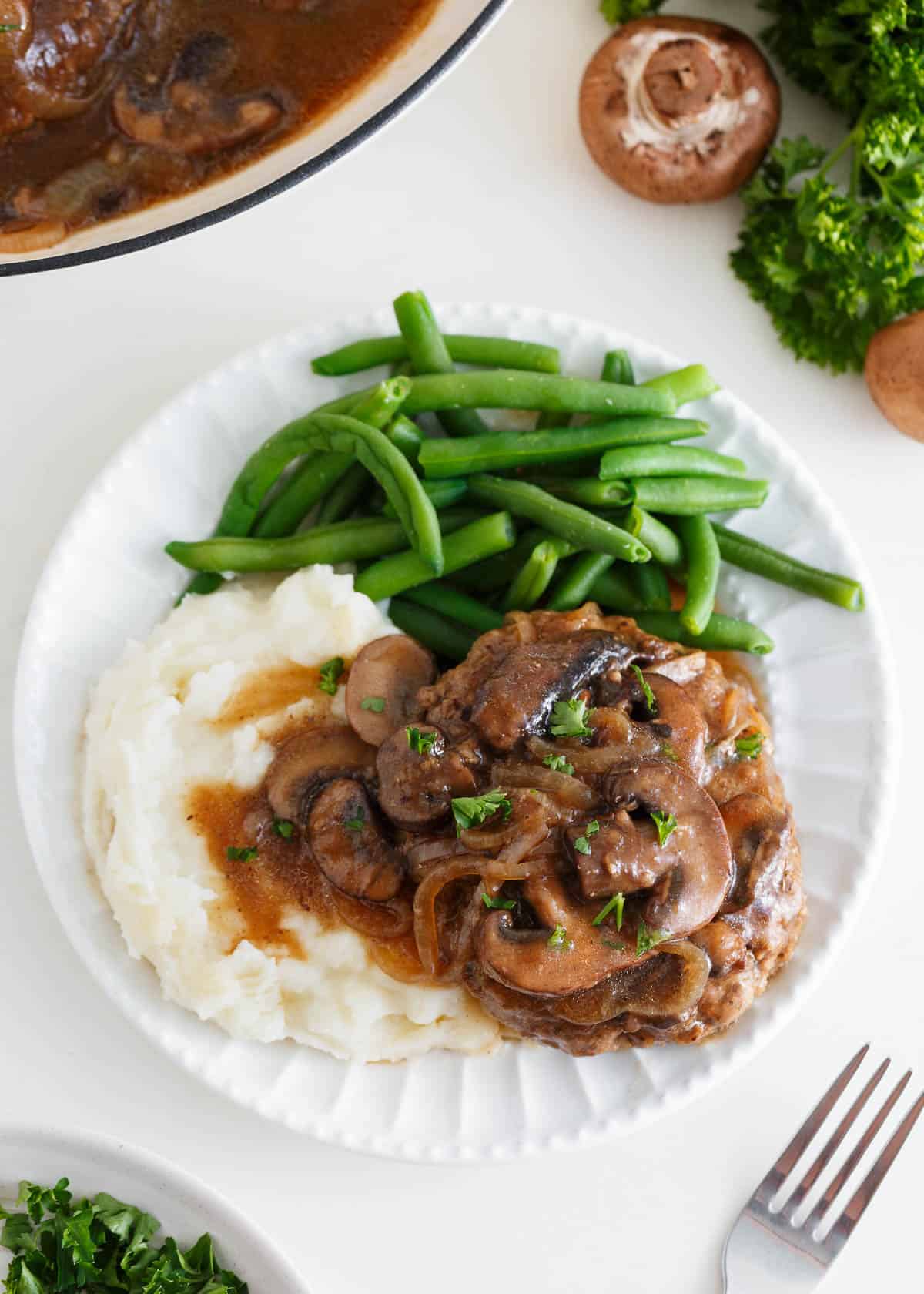 Salisbury steak with mashed potatoes and green beans.