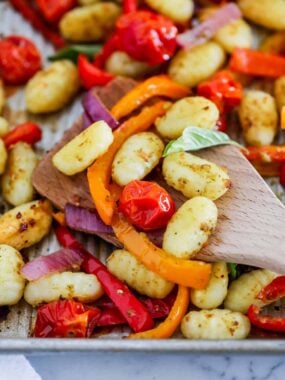 Close of up sheet pan gnocchi on a large baking sheet.