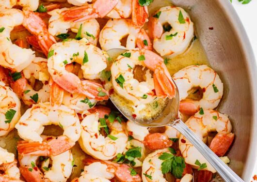 Cooking shrimp scampi in a pot.