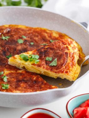 Slice of Spanish omelette in a skillet.