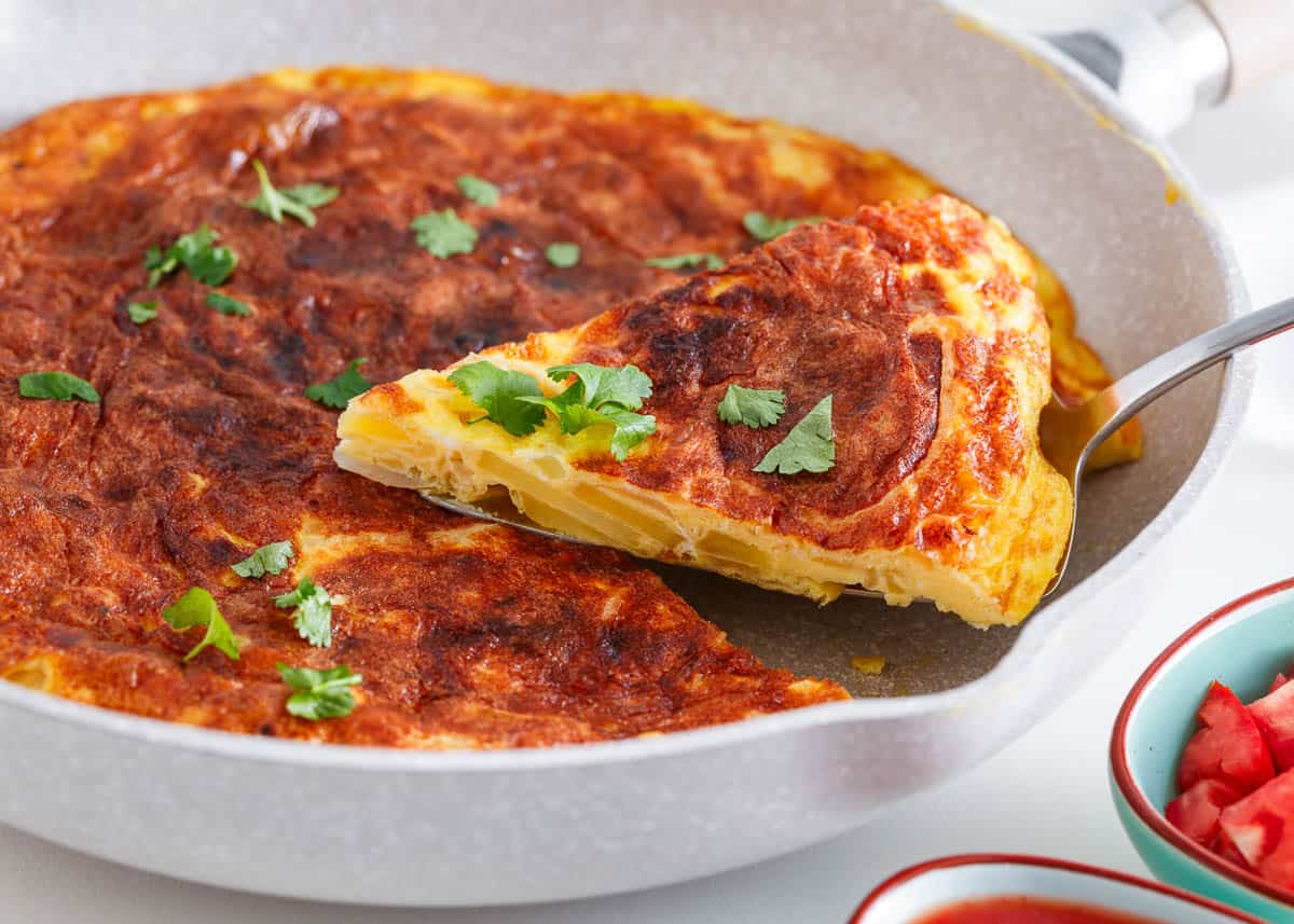 Slice of spanish omelette in a pan.