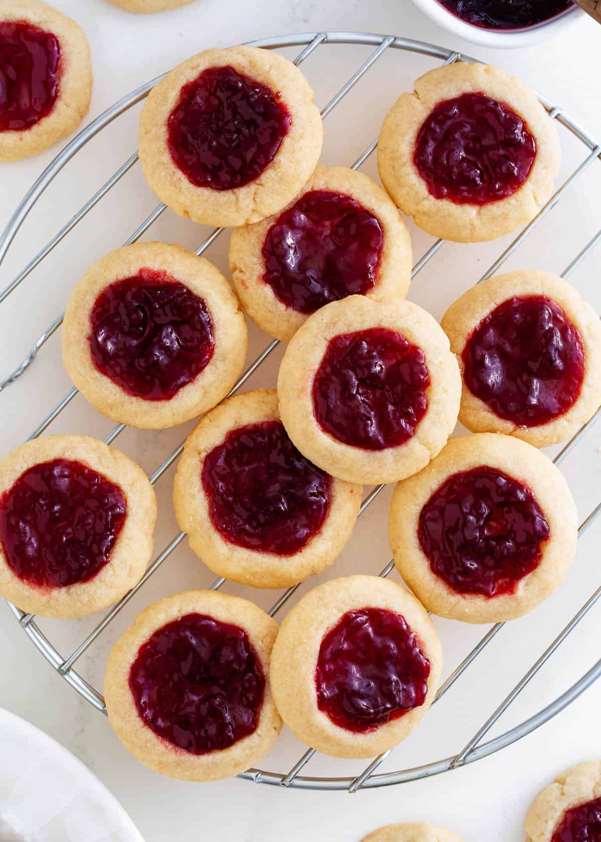 Thumbprint cookies on a cooling rack.