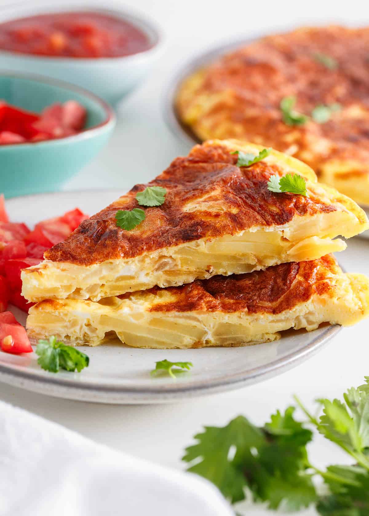 Tortilla espanola slices on a plate.