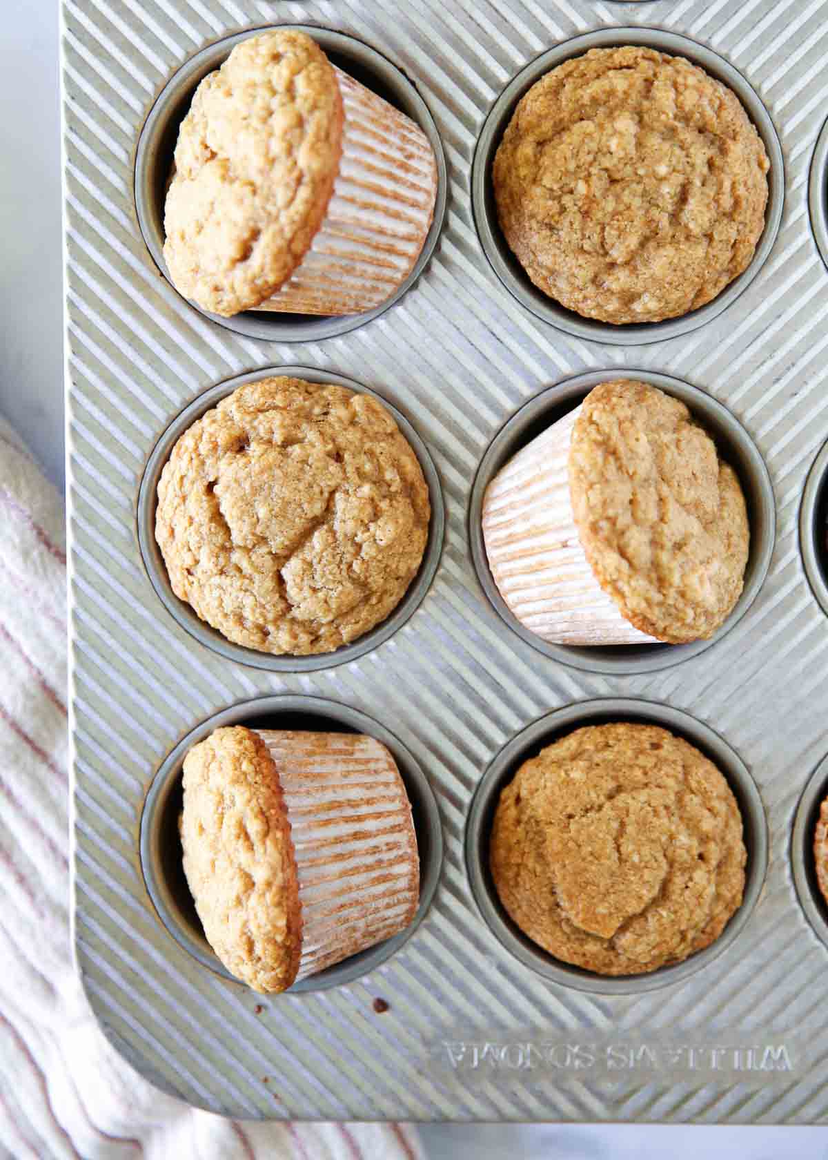Applesauce muffins in a muffin tin.