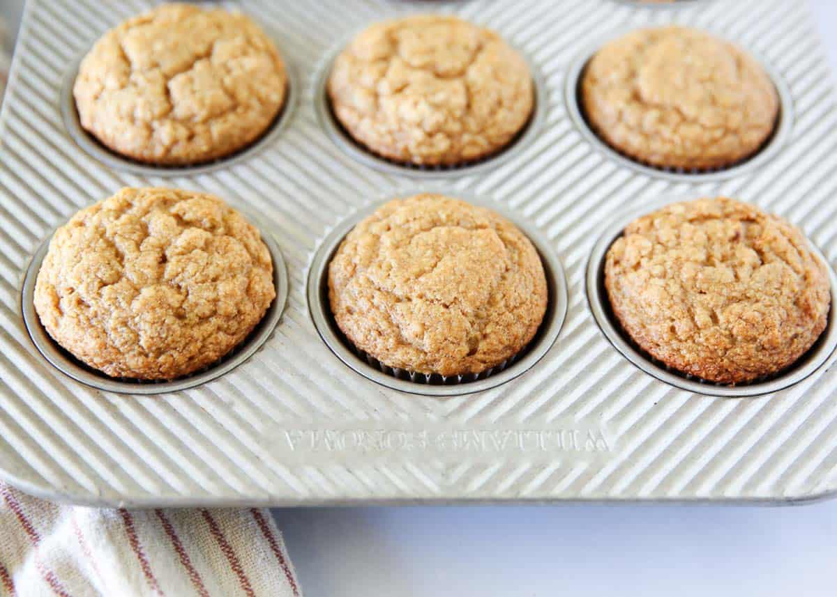 Applesauce muffins in a muffin tin.