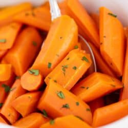 Brown sugar carrots in a white bowl.