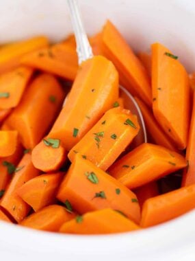 Brown sugar carrots in a white bowl.