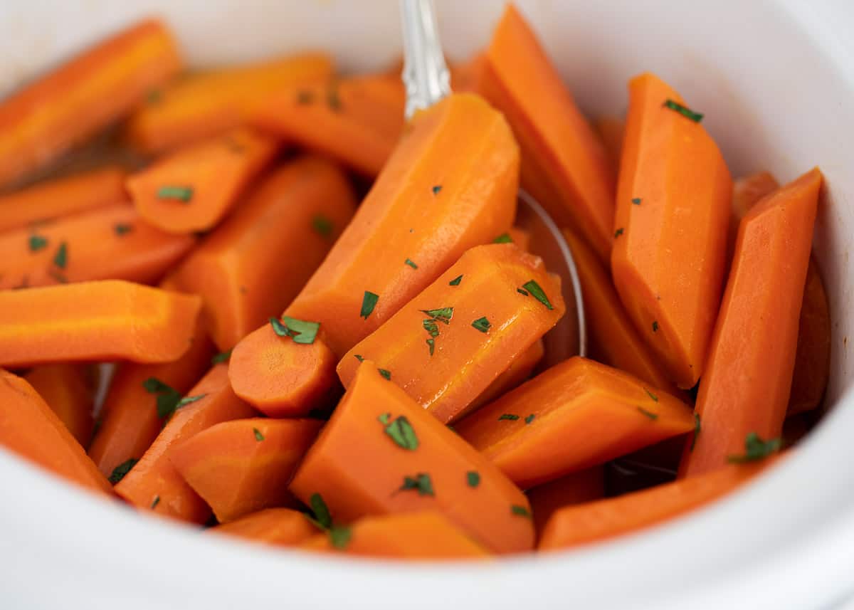 Brown sugar glazed carrots in a white bowl.