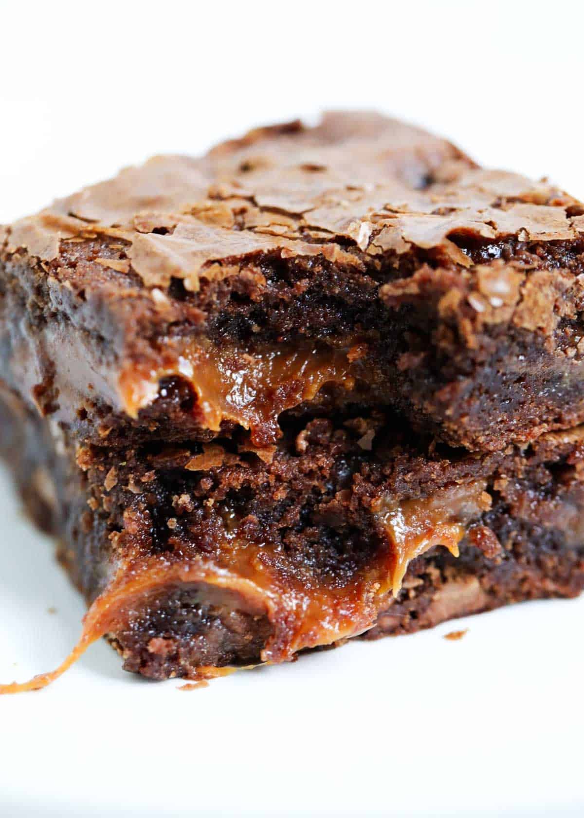 Easy to make chocolate caramel brownies that are loaded with chocolate chips and layers of gooey caramel. Rich, chewy and simply amazing! Caramel brownies stacked on top of each other.