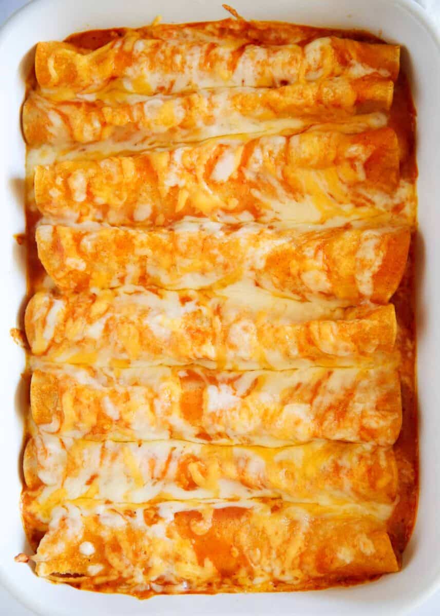 Cheese enchiladas in a white baking dish.