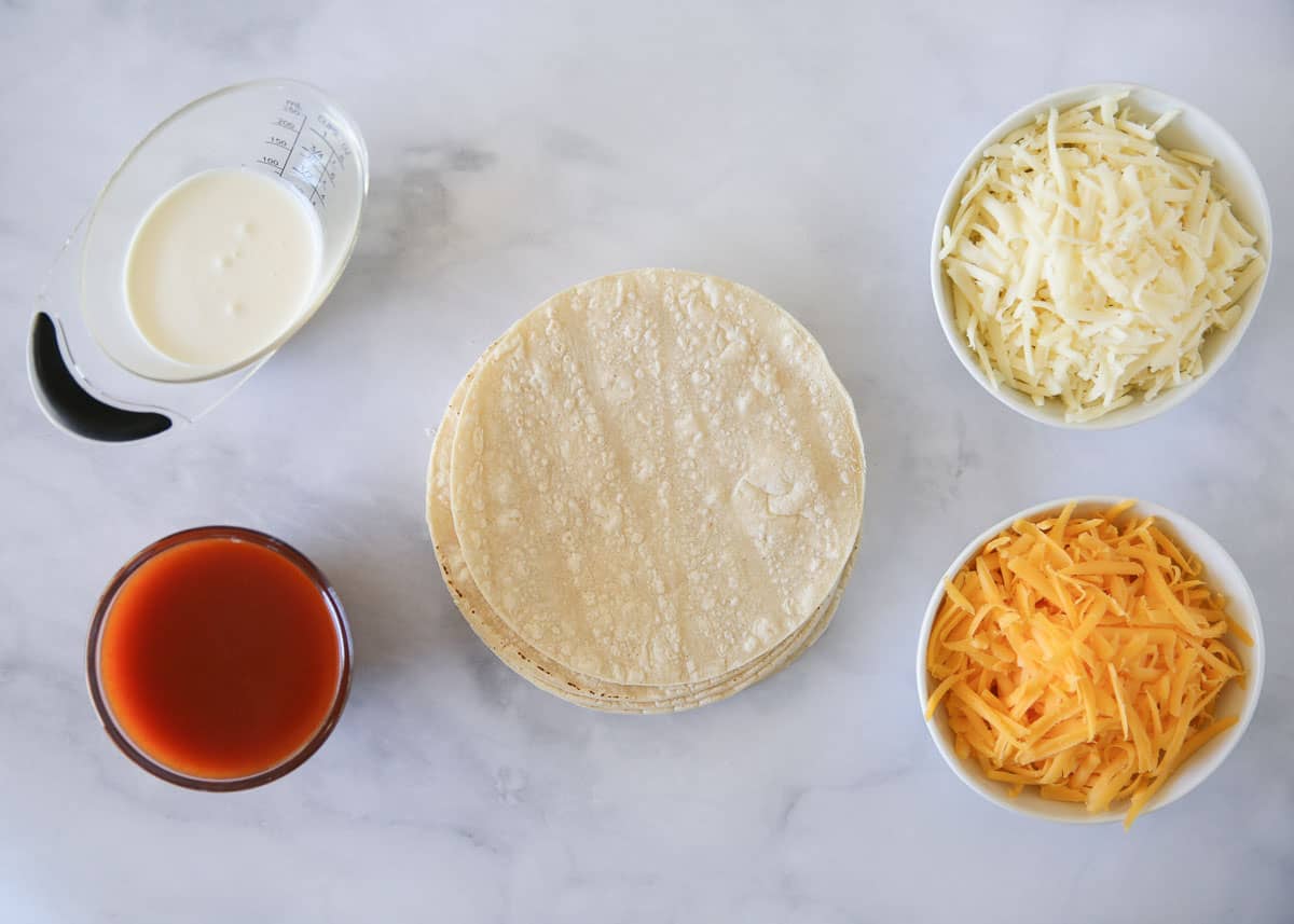 Cheese enchilada ingredients on counter.