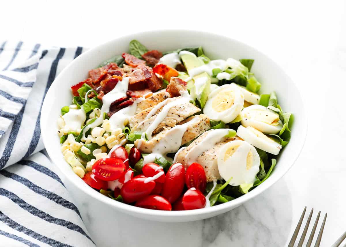 Cobb salad with dressing on top. 