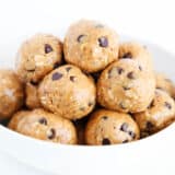 Energy balls stacked in a white bowl.