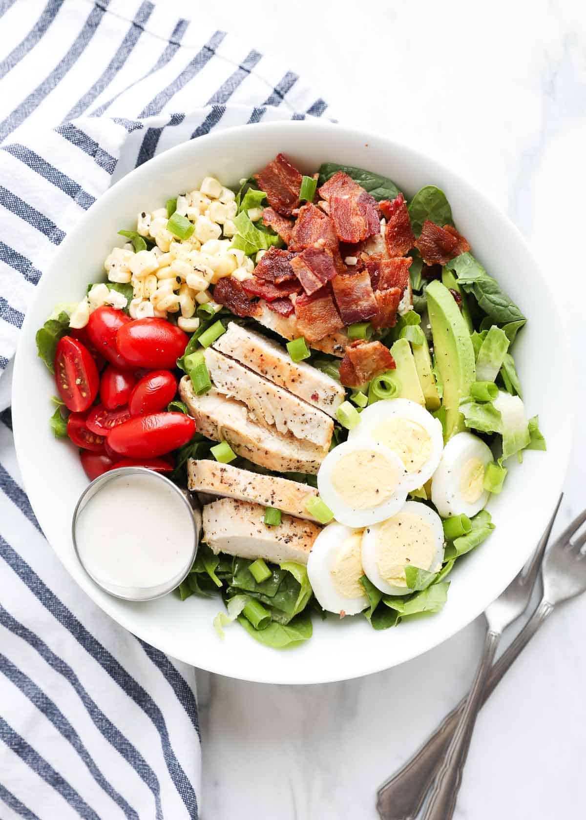 Cobb salad in a white bowl. 