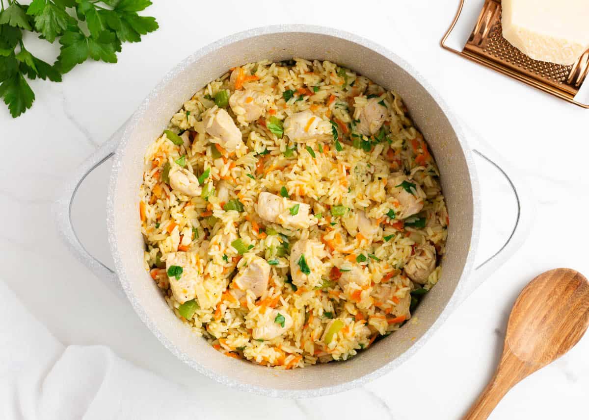 Finished one pot chicken and rice garnished with fresh parsley in the pot.