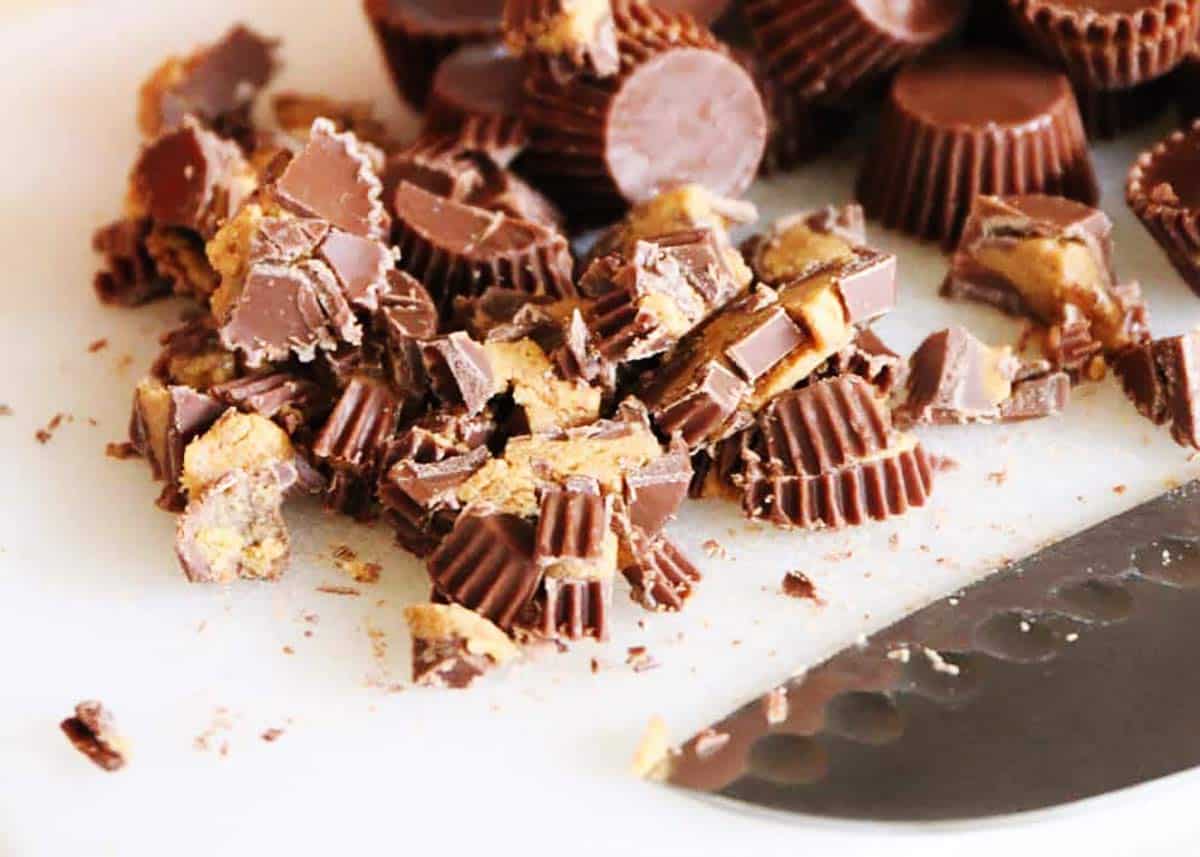 Reese's cups cup up on a white cutting board.