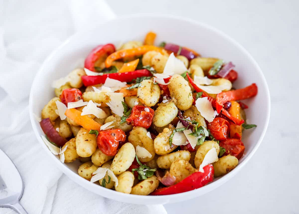 Sheet pan gnocchi in a white bowl. 