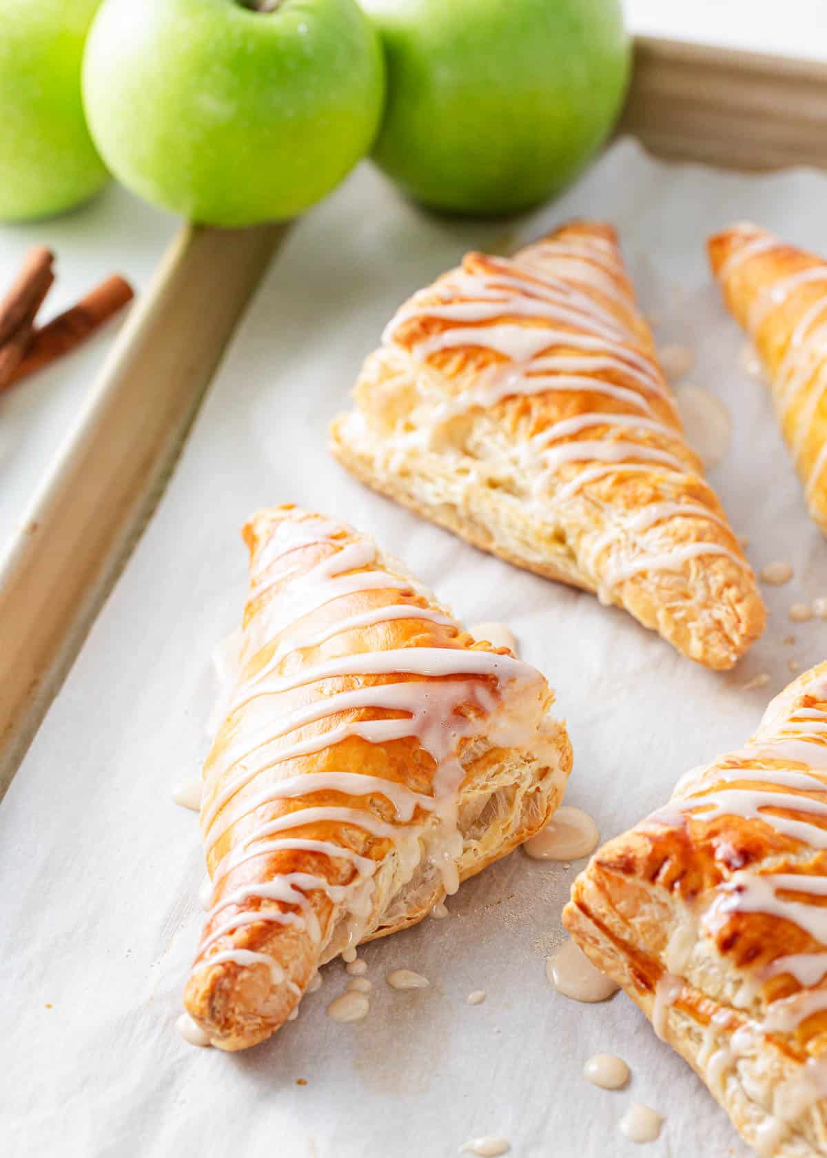 Apple turnovers on a baking sheet.