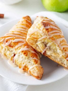 Apple turnovers on a white plate.