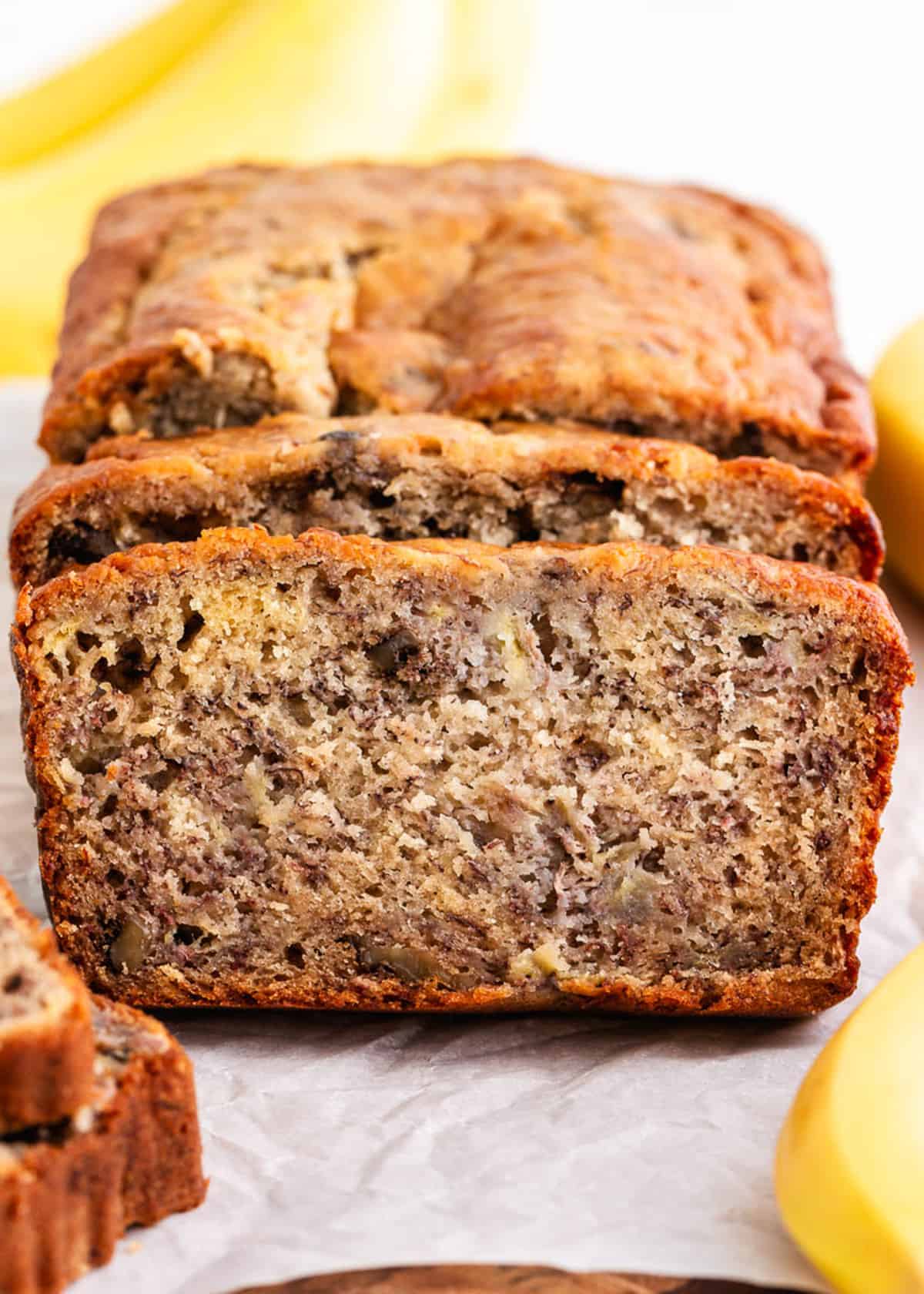 Sliced banana bread on parchment paper.