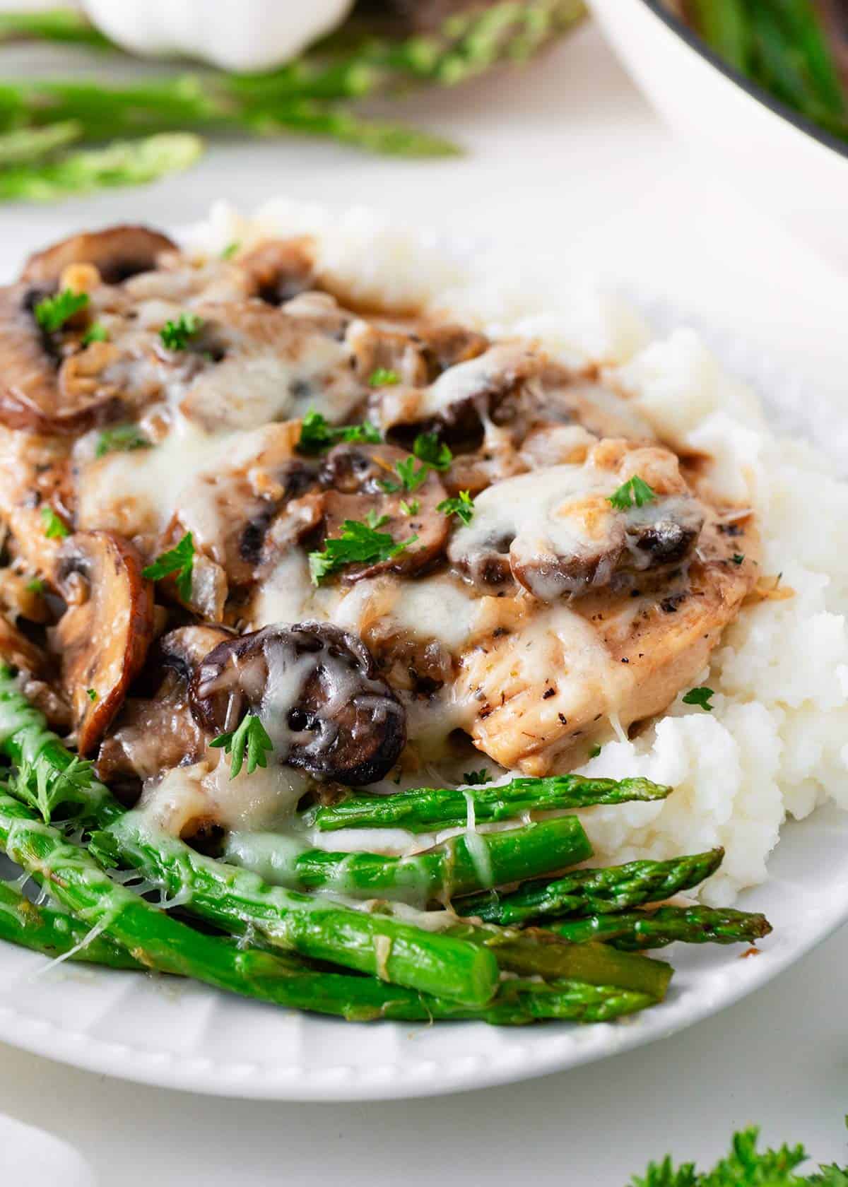 Chicken madeira and mashed potatoes on a white plate.