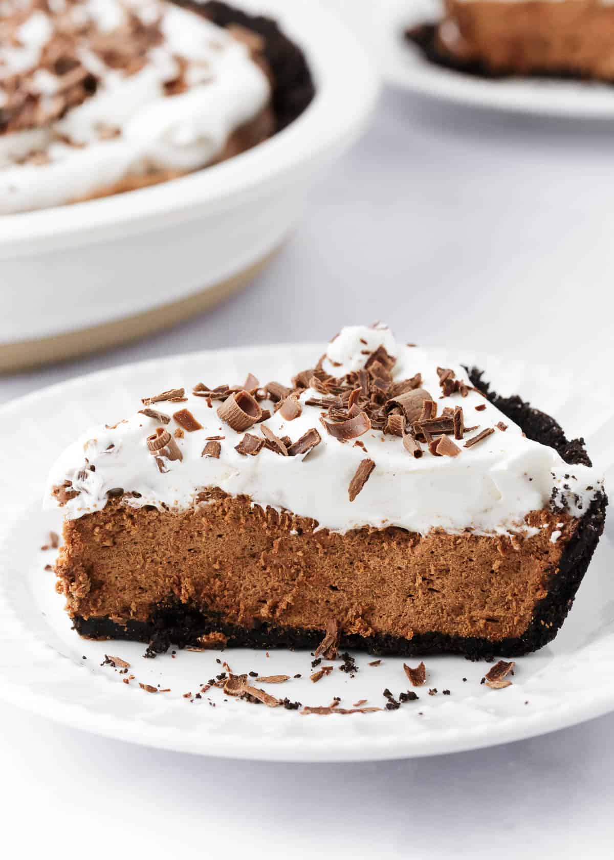 A slice of french silk pie on a white plate. 