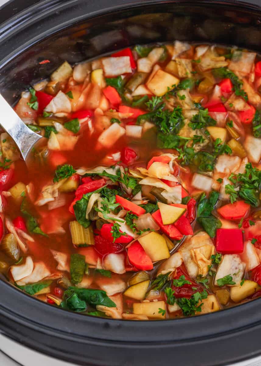 Crockpot cabbage soup being served from slow cooker.