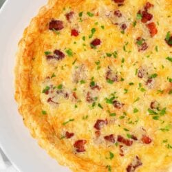 Quiche lorraine on a white plate.