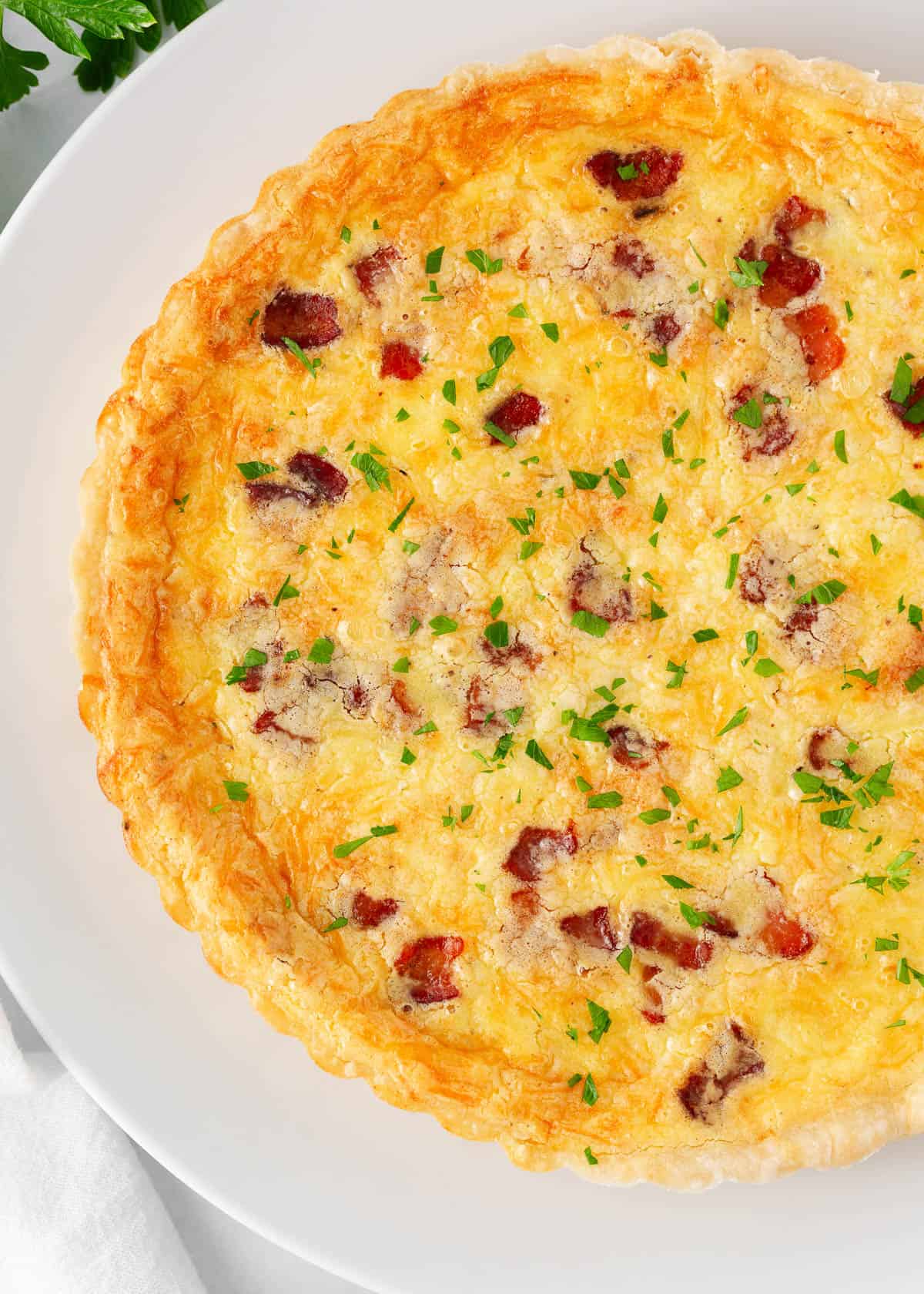 Quiche lorraine on a white plate.