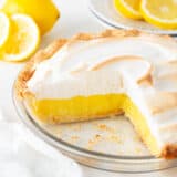 Lemon meringue pie sliced in dish.