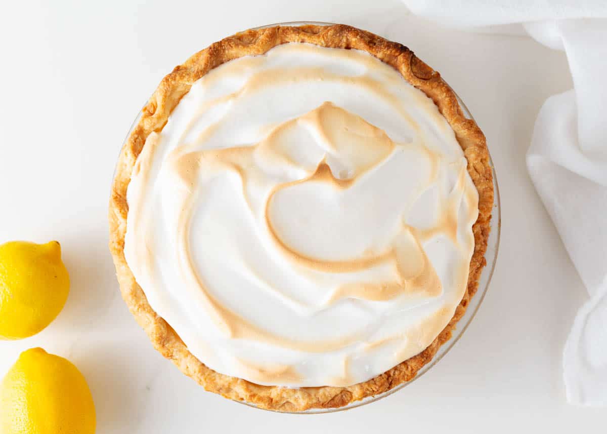 Lemon meringue pie in a glass pie dish.