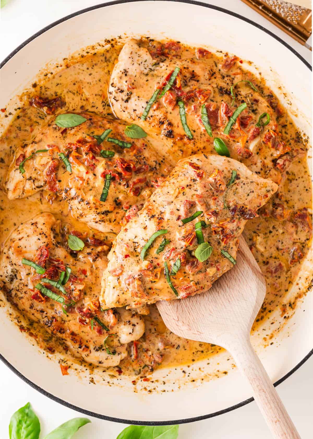 A skillet with marry me chicken recipe.