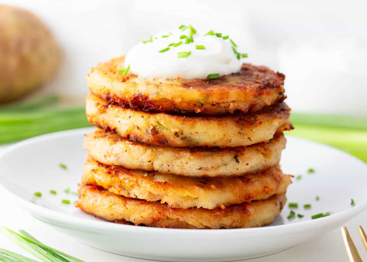 Stacked mashed potato pancakes on a plate. 