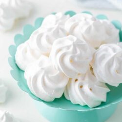 Meringue cookies on a cake platter.