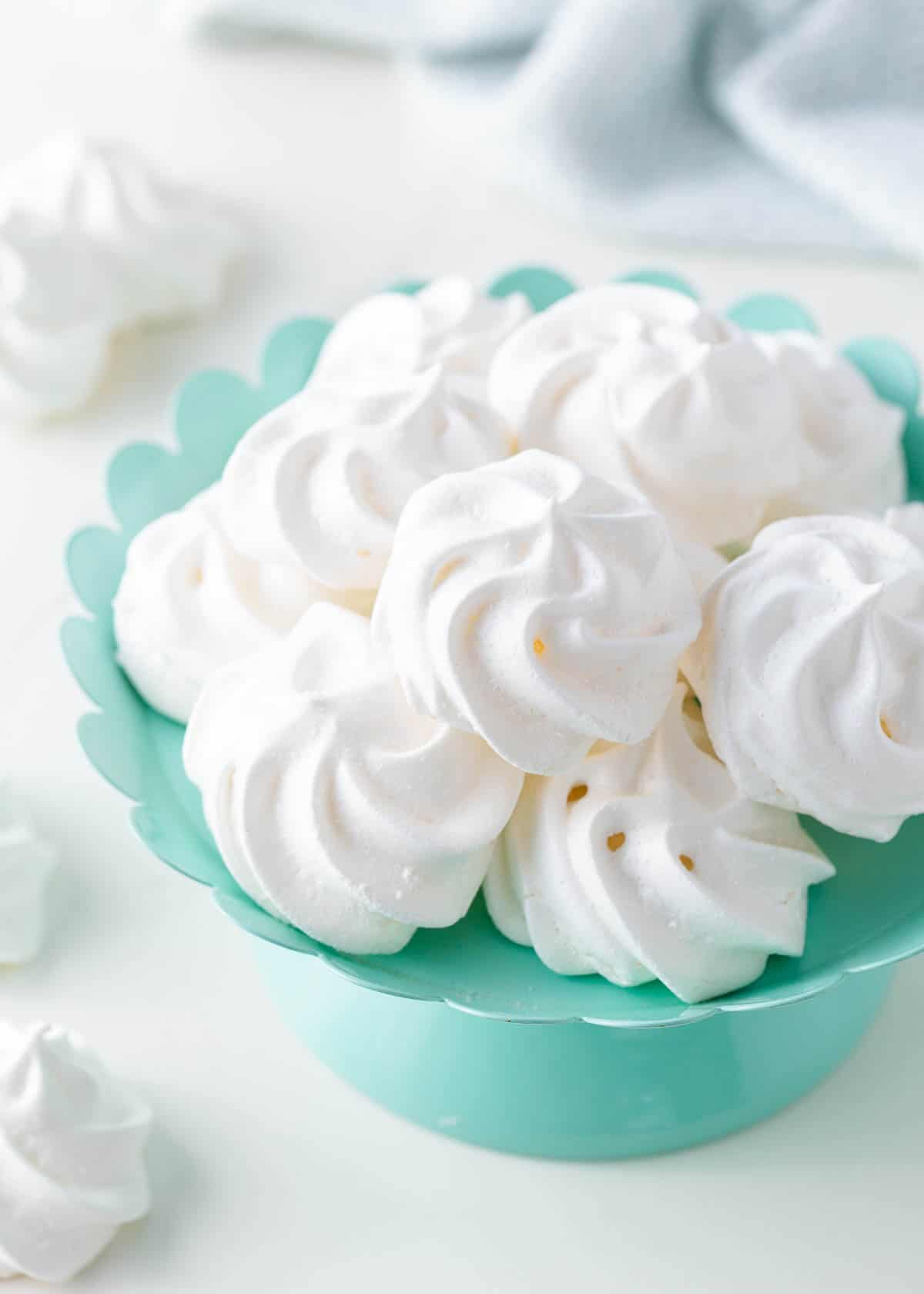 Meringue cookies on a cake platter.