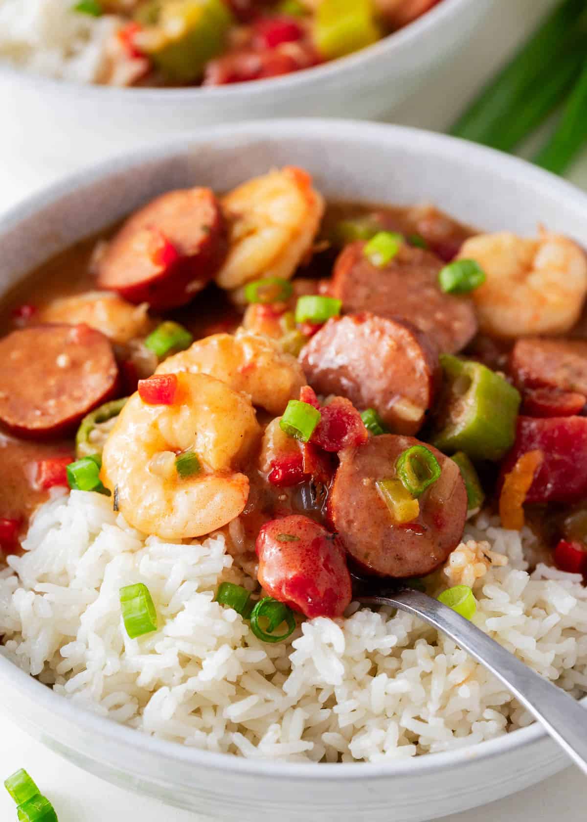 A bowl of New Orleans gumbo with a serving spoon.