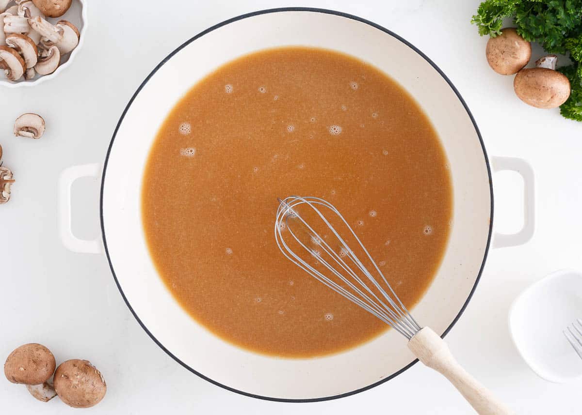 Salisbury steak gravy in a white pot.