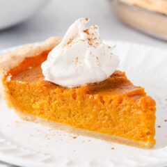 Slice of sweet potato pie on a white plate.