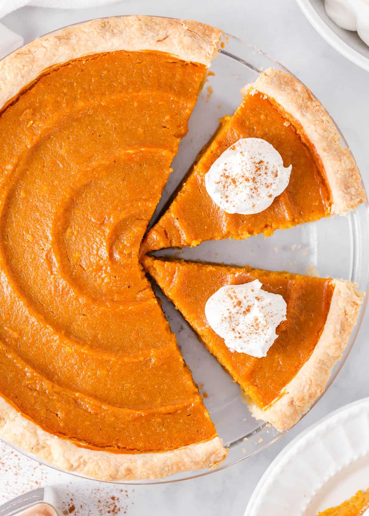 Slices of sweet potato pie in a pie dish. 