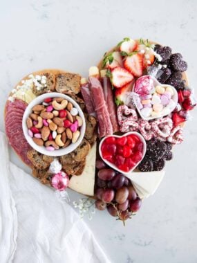 Valentine charcuterie board on marble counter.