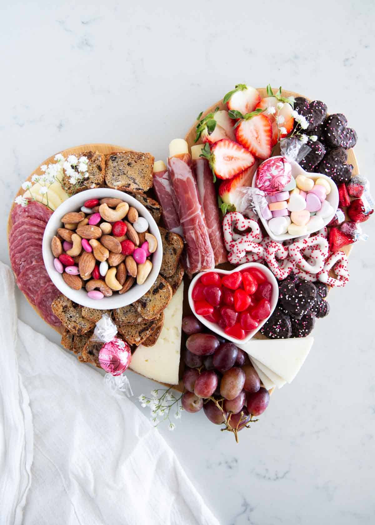 Valentine charcuterie board on marble counter.