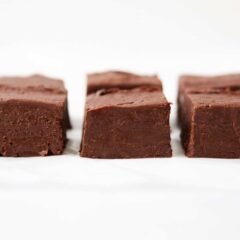3 ingredient chocolate fudge cut into squares on the counter.