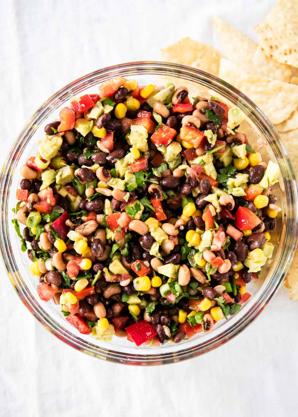 Cowboy caviar mixed together with tortilla chips on the side. 