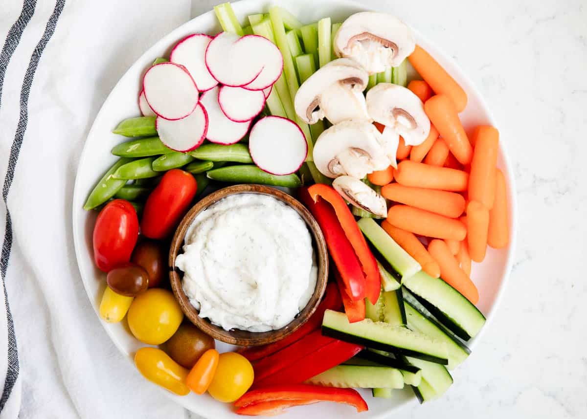 Dill dip on a plate with veggies. 