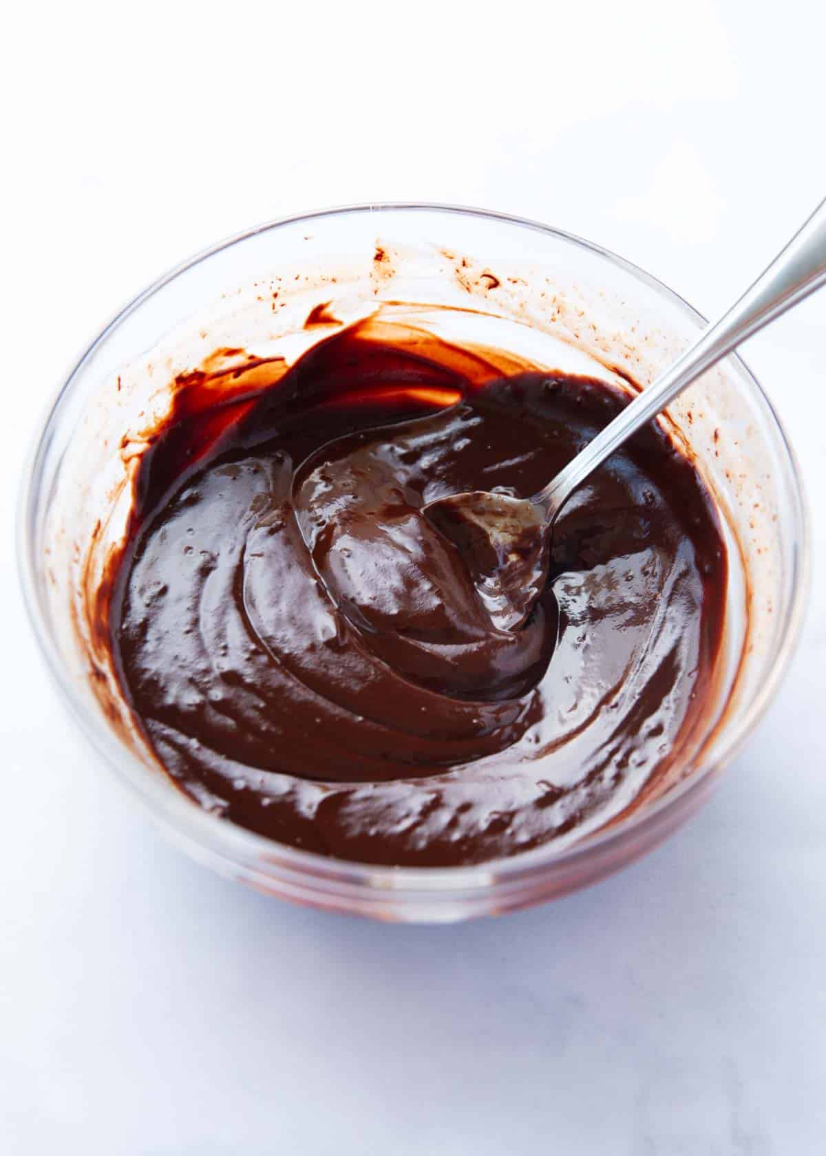 Melted chocolate in a glass bowl.