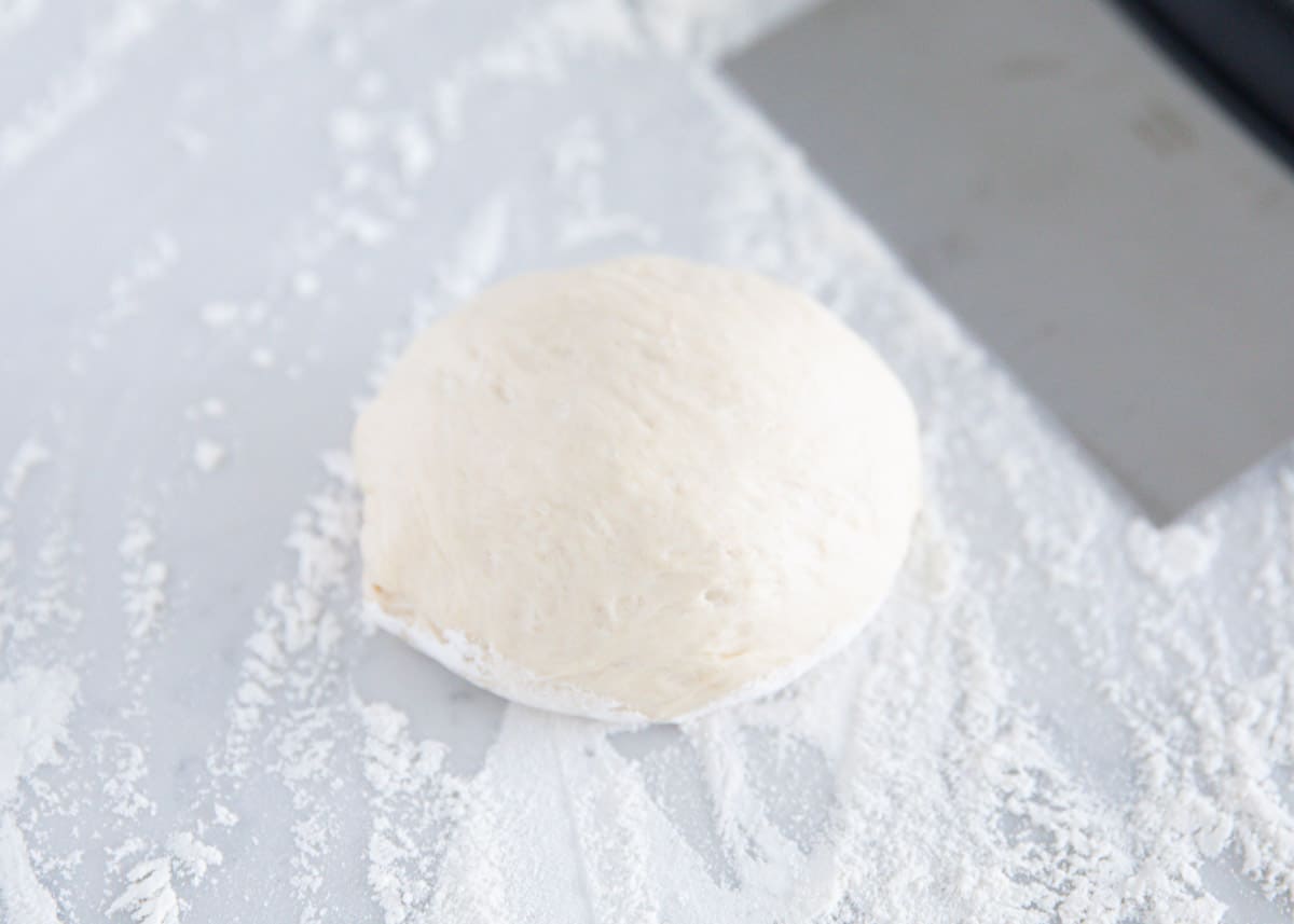 Flour tortilla dough rolled into a ball. 