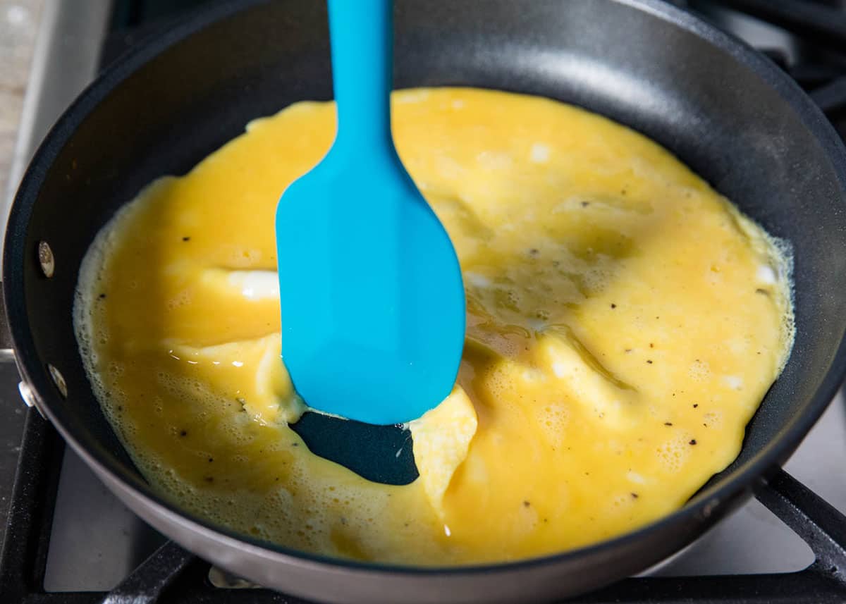 Cooking an omelette in a black skillet. 