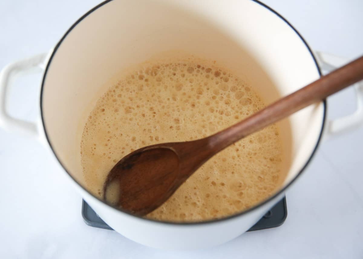 Cooking white sauce pasta in a pot. 